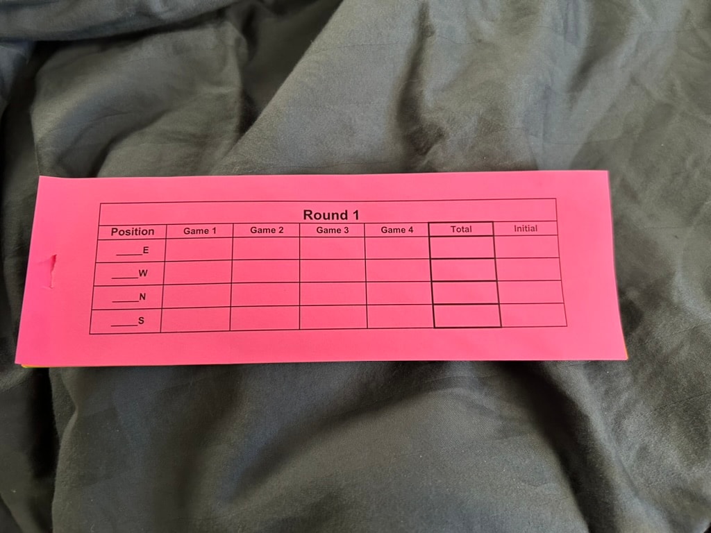 Pink Mah Jongg tournament scorecard showing Round 1 with positions East, West, North, South