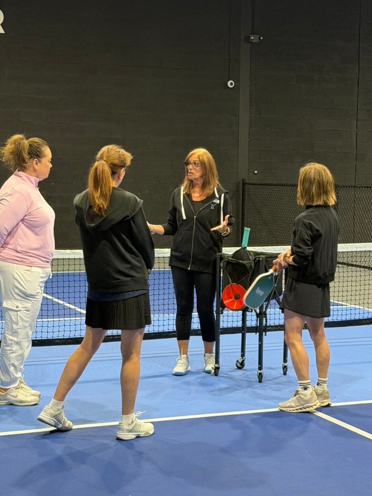 Picklr clinic instructor coaching players on the court