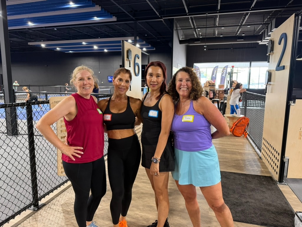 Four women smiling together at The Picklr during social play
